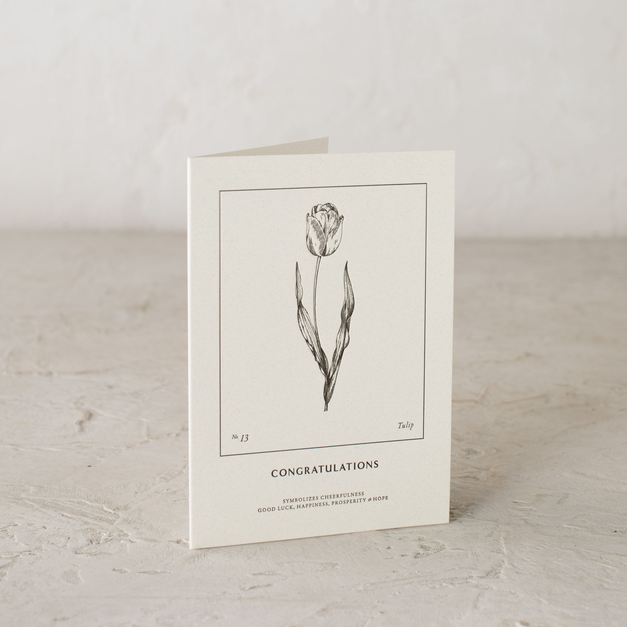 Embossed botanical greeting card. Tulip illustration, under reads "Congratulations" Symbolizes cheerfulness good luck happiness, prosperity and hope. Designed and sold by Shop Verdant Kansas City gift card.